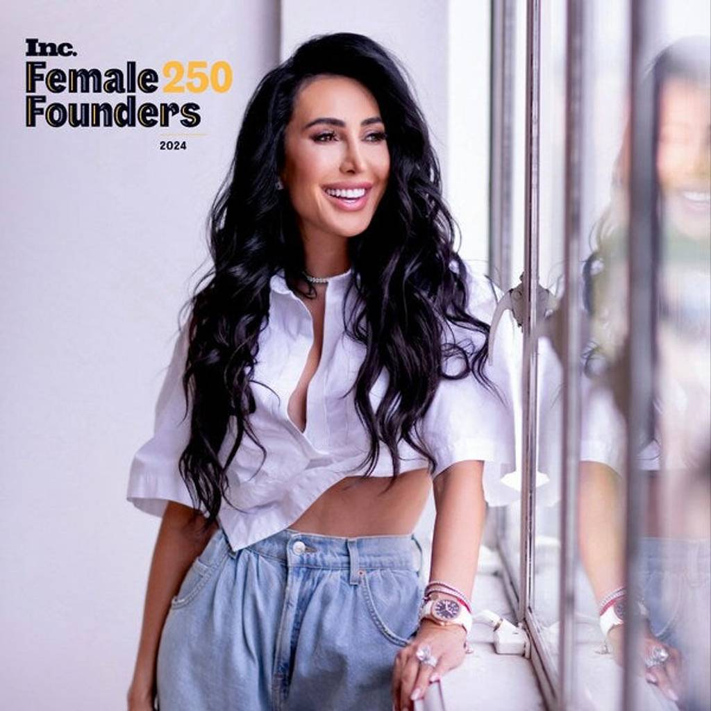 Smiling woman in a white cropped blouse and jeans beside a window, with Inc. Female Founders 250 2024 text.