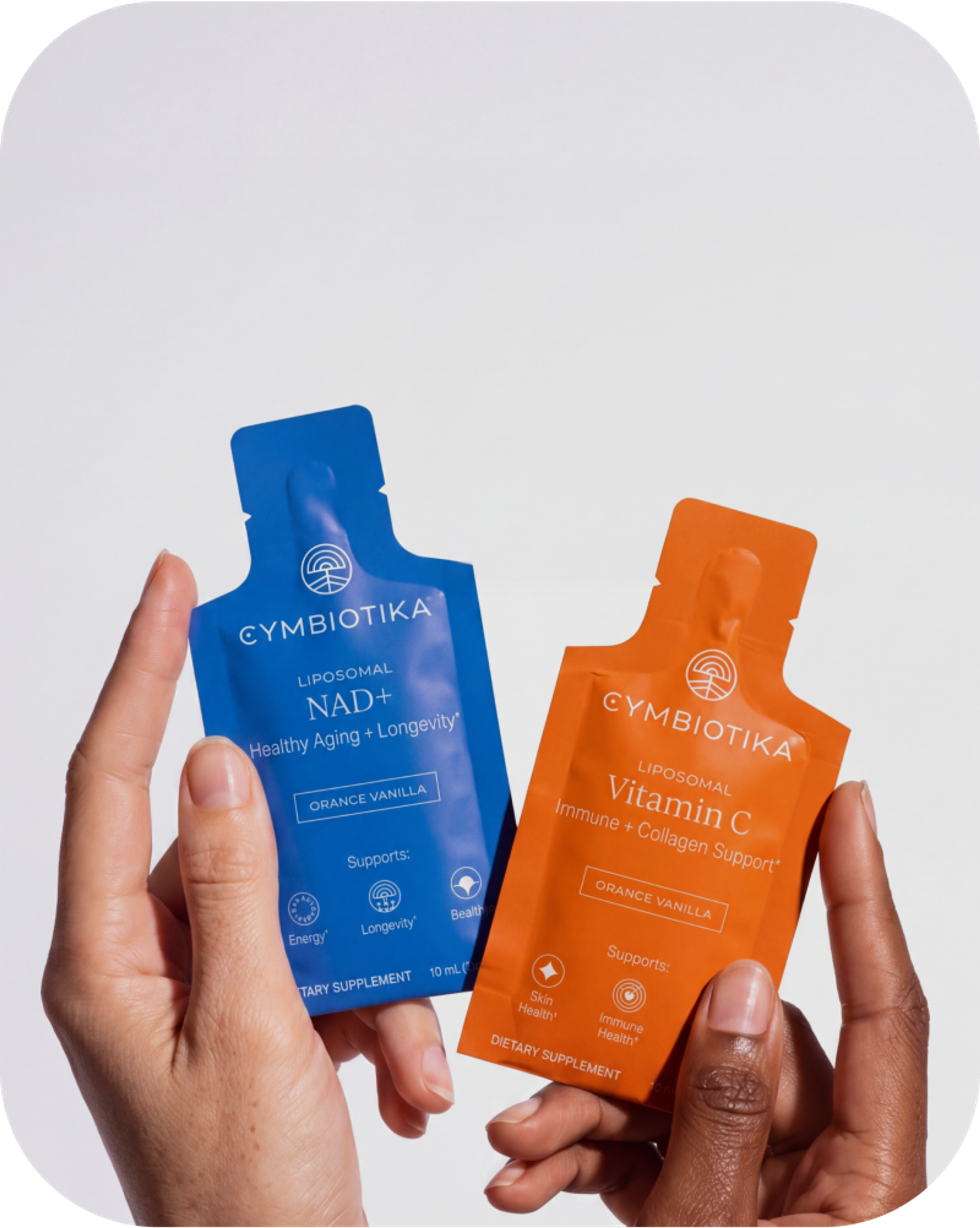 Hands hold blue Liposomal NAD+ and orange Liposomal Vitamin C sachets.