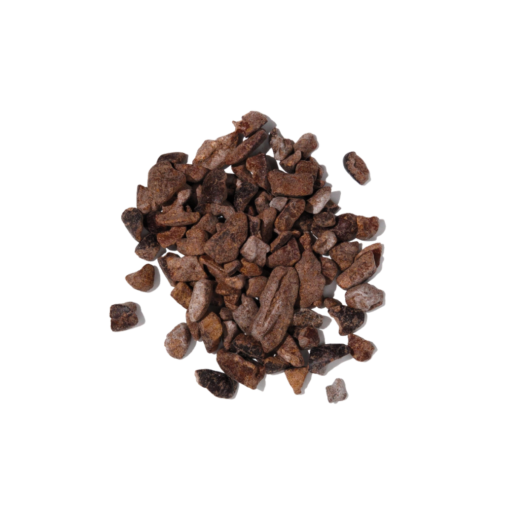 Pile of irregular dark brown cacao pieces, shown as an ingredient visual.