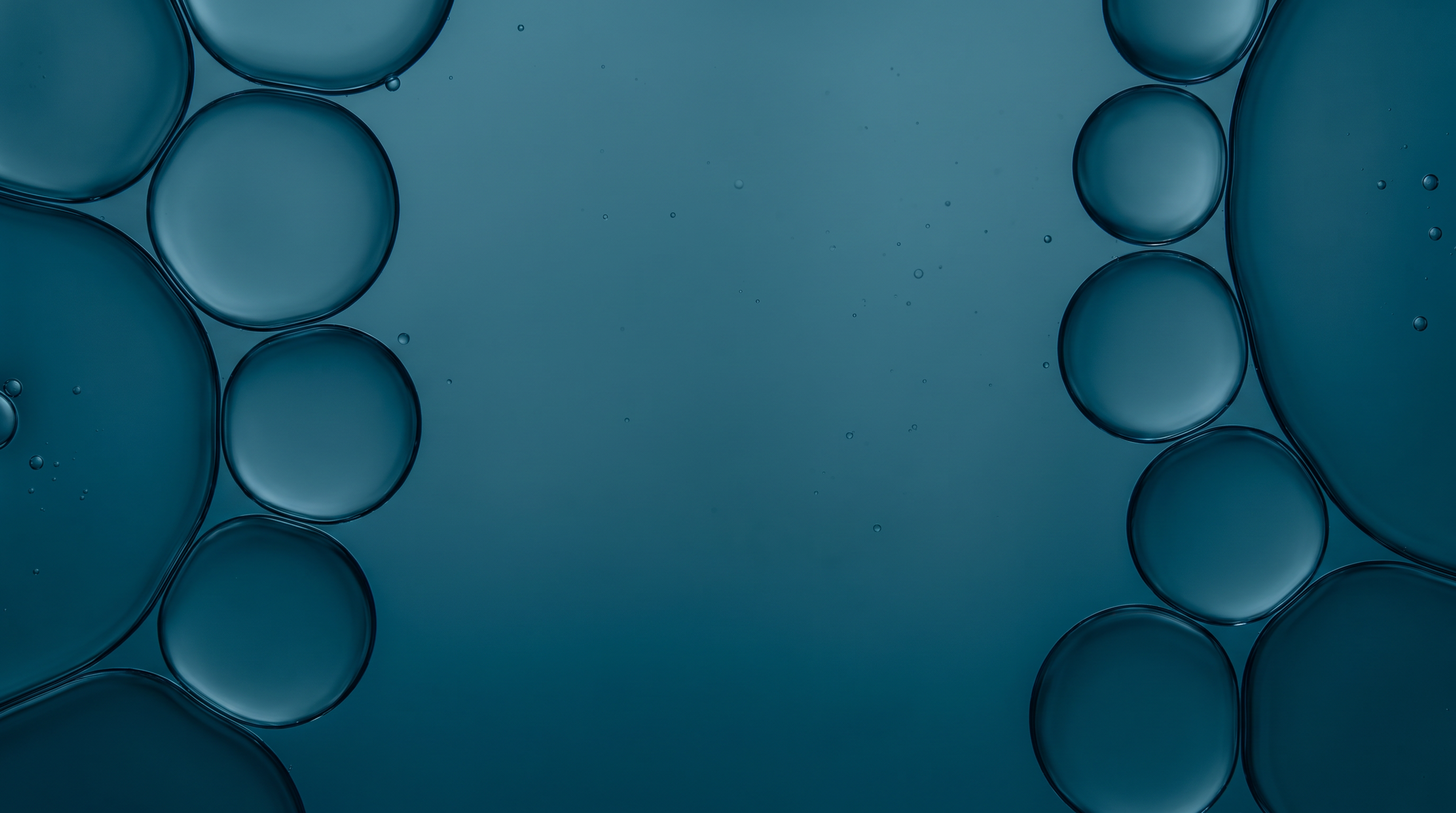 Abstract teal field with translucent circular bubbles clustered along the edges.
