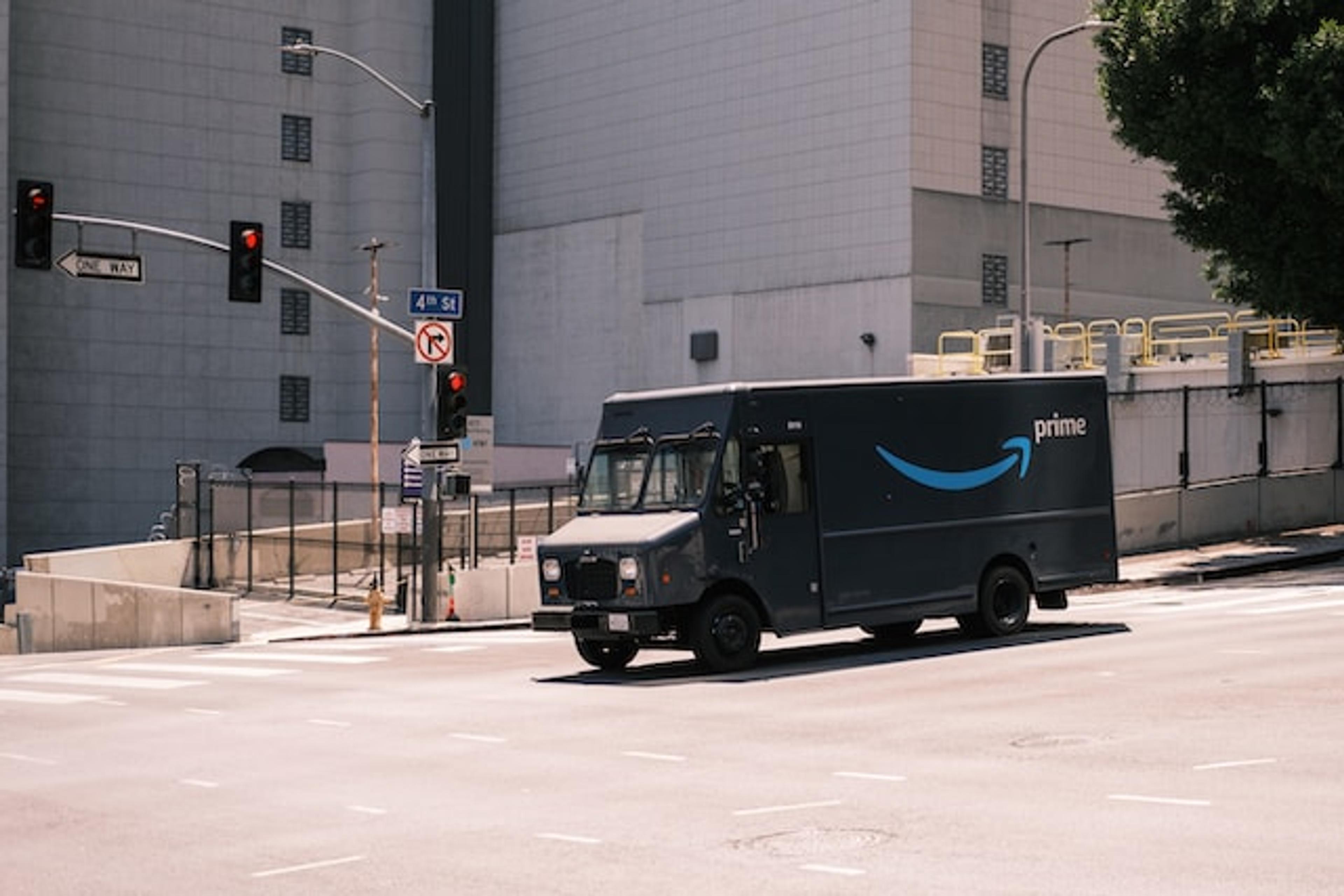 Amazon Prime truck driving by on an empty street.