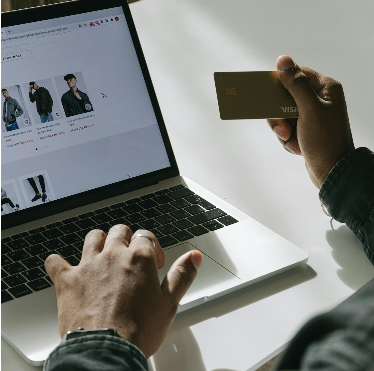 Man typing his credit card information into a payment processor on an eCommerce store