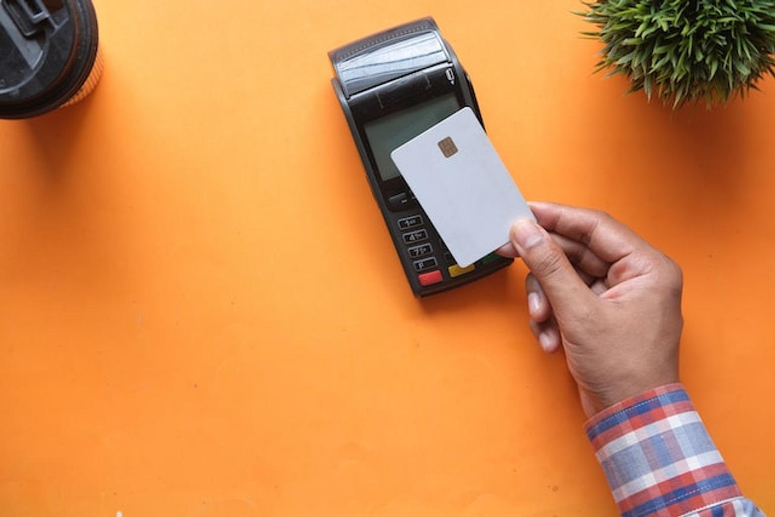 Credit card payment on orange background.