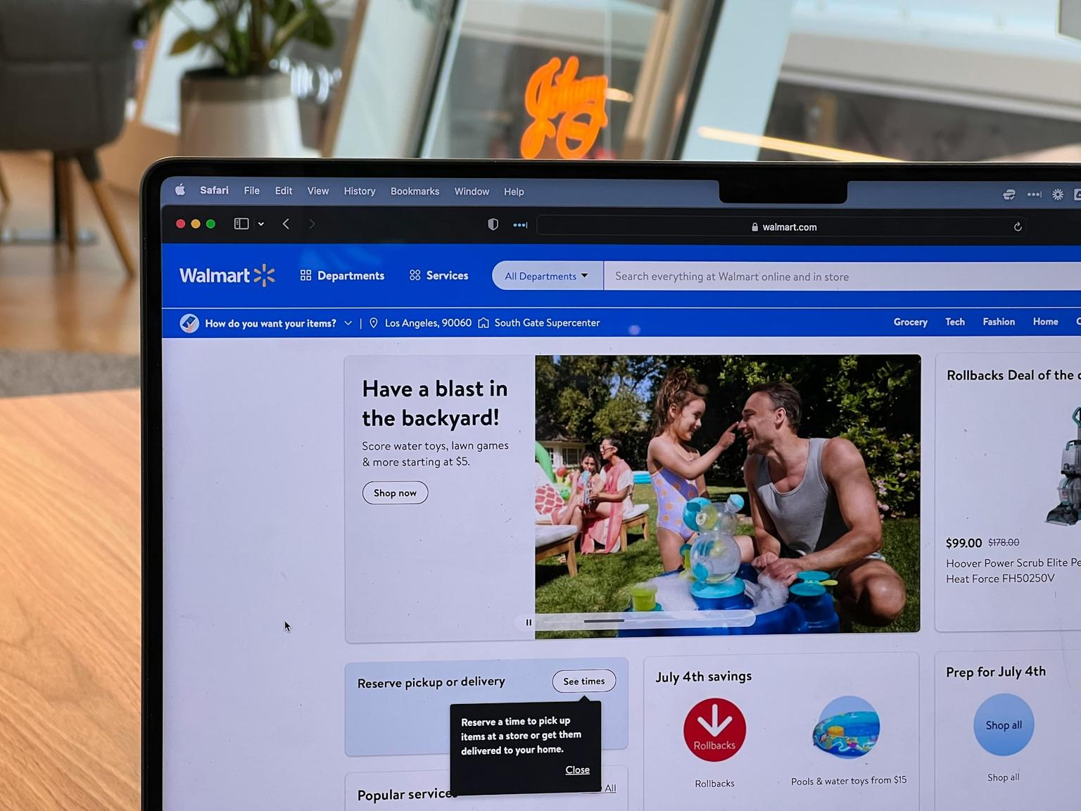 A laptop on a desk with Walmart Marketplace opened in its browser.