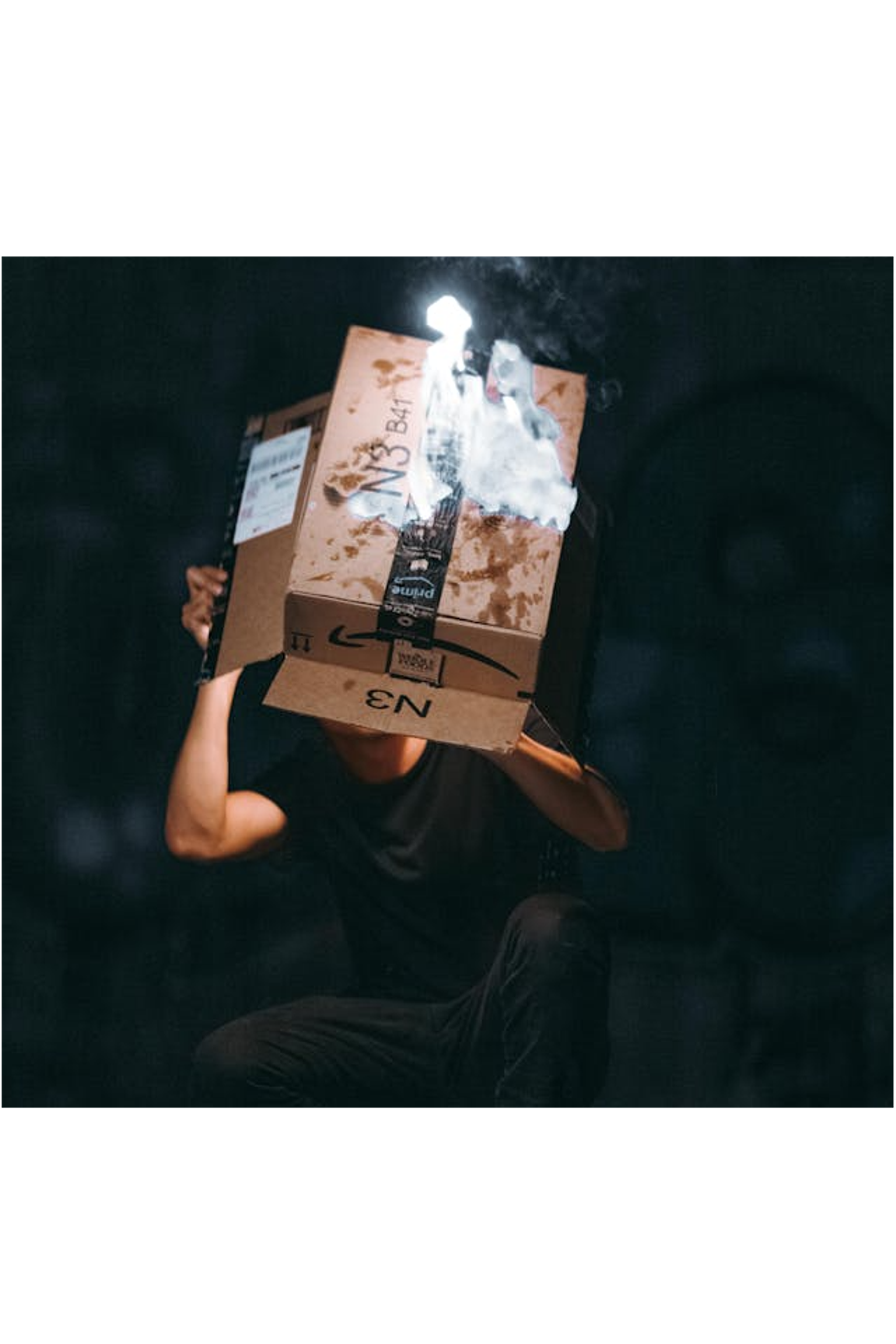 Person with a burning Amazon box on their head, symbolizing frustration or a disastrous mistake with Amazon decision.