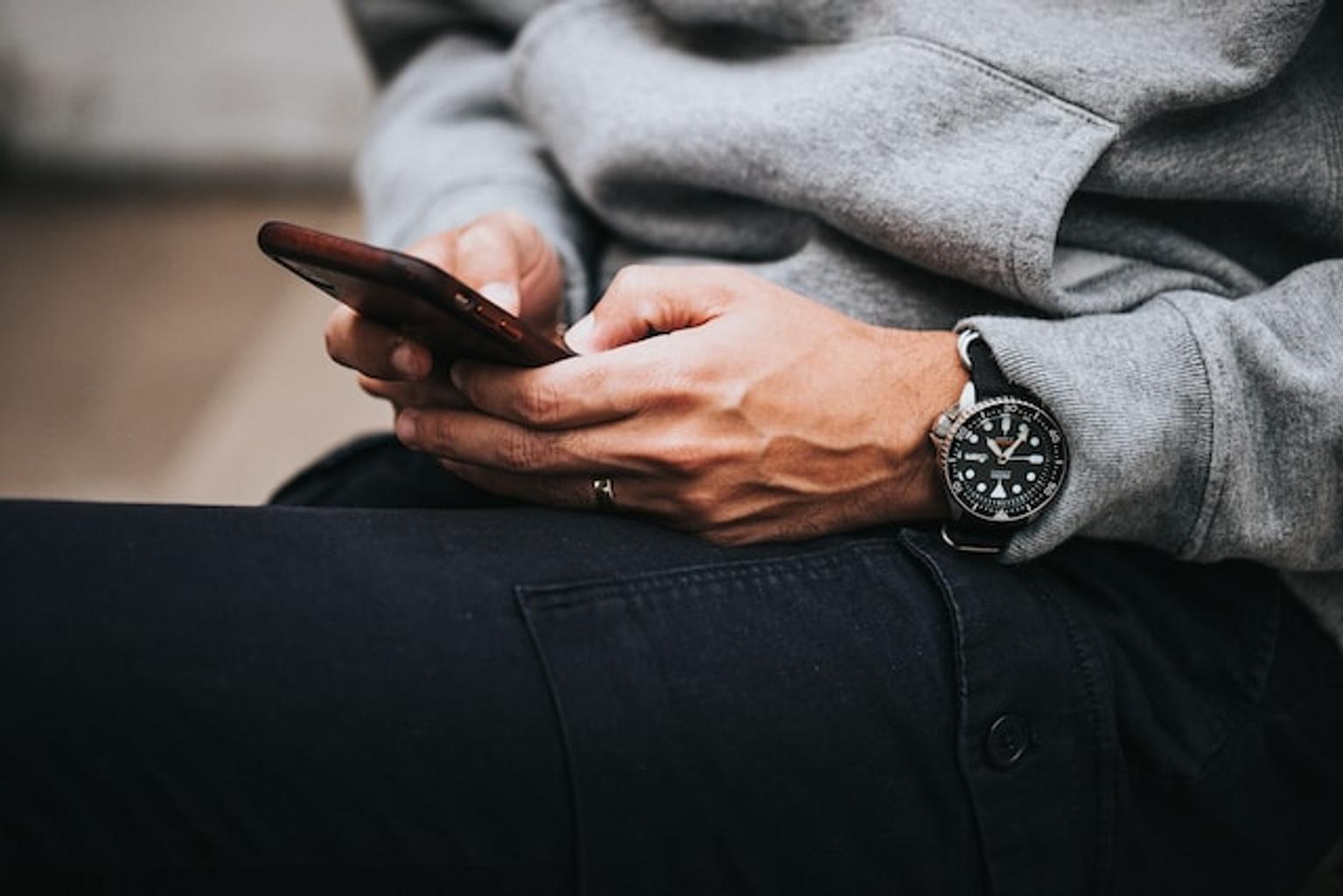 Man typing on a mobile phone