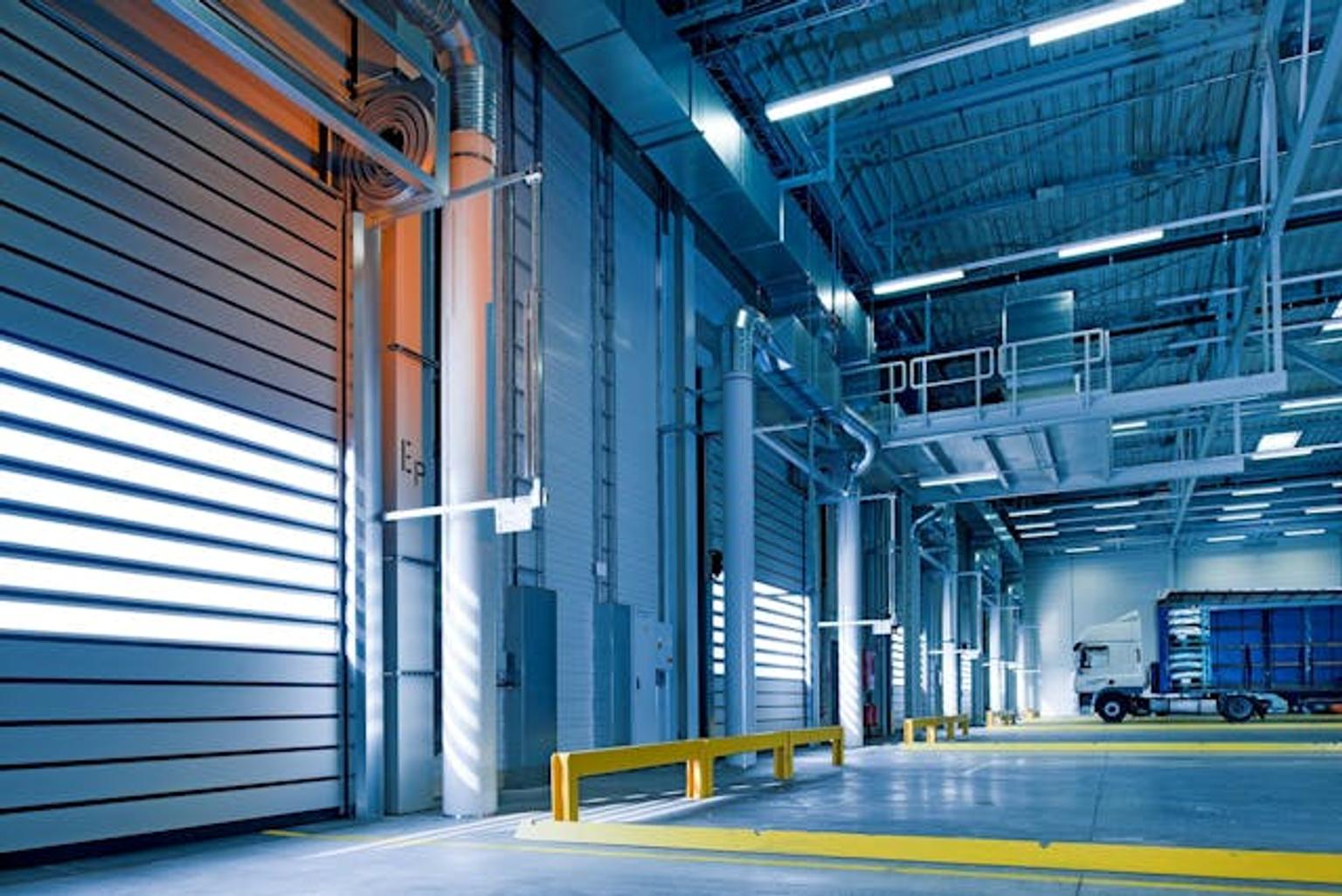 Empty interior of a fulfilment facility with a truck leaving to deliver products