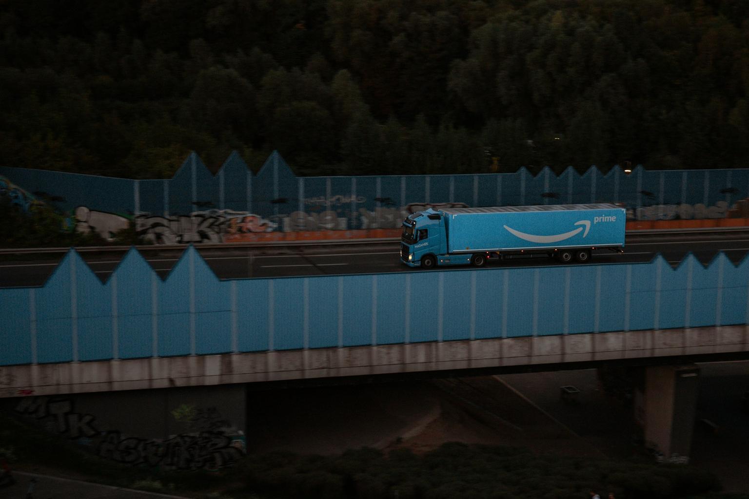 Amazon truck moving on the highway with prime logo