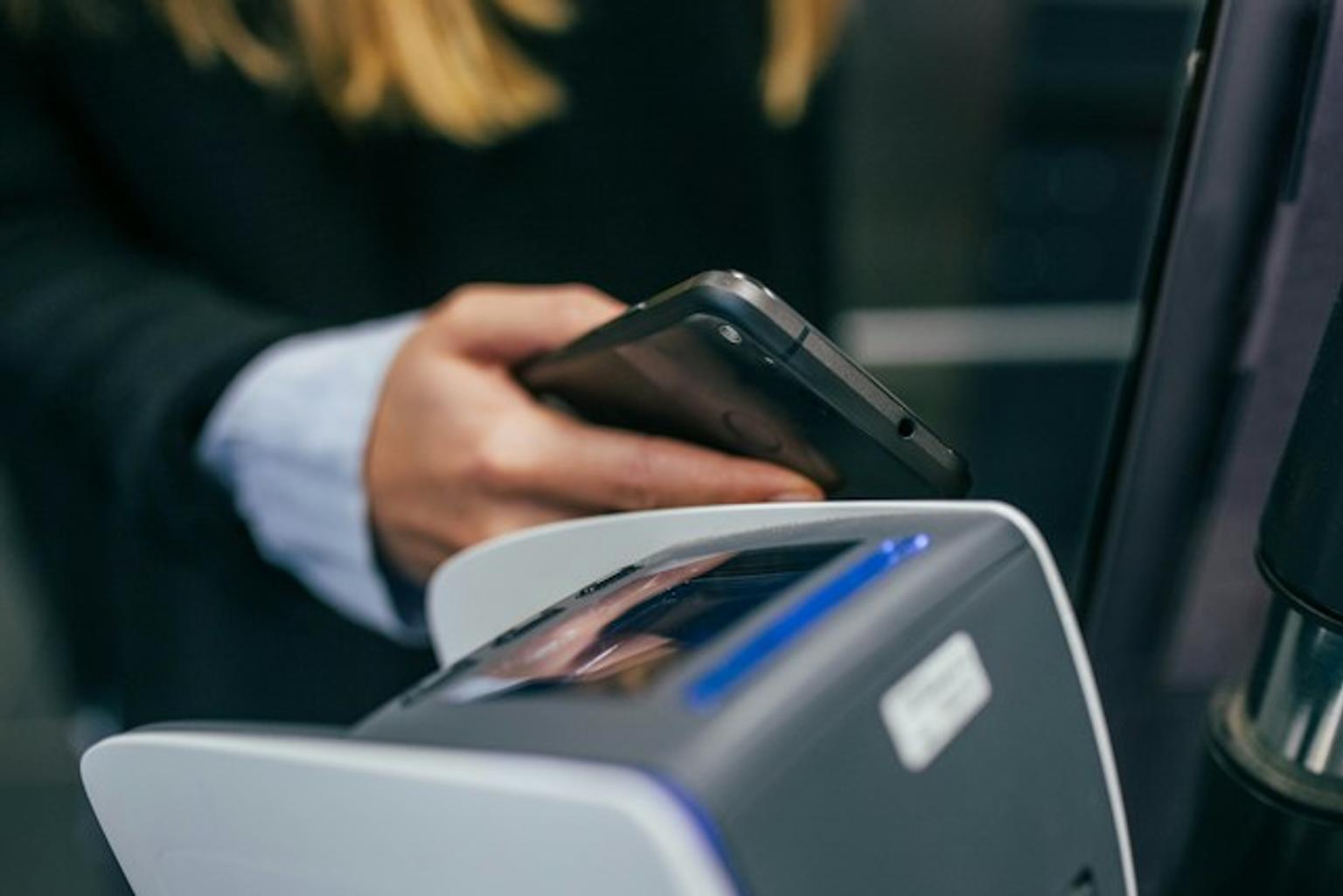 Person paying with smartphone