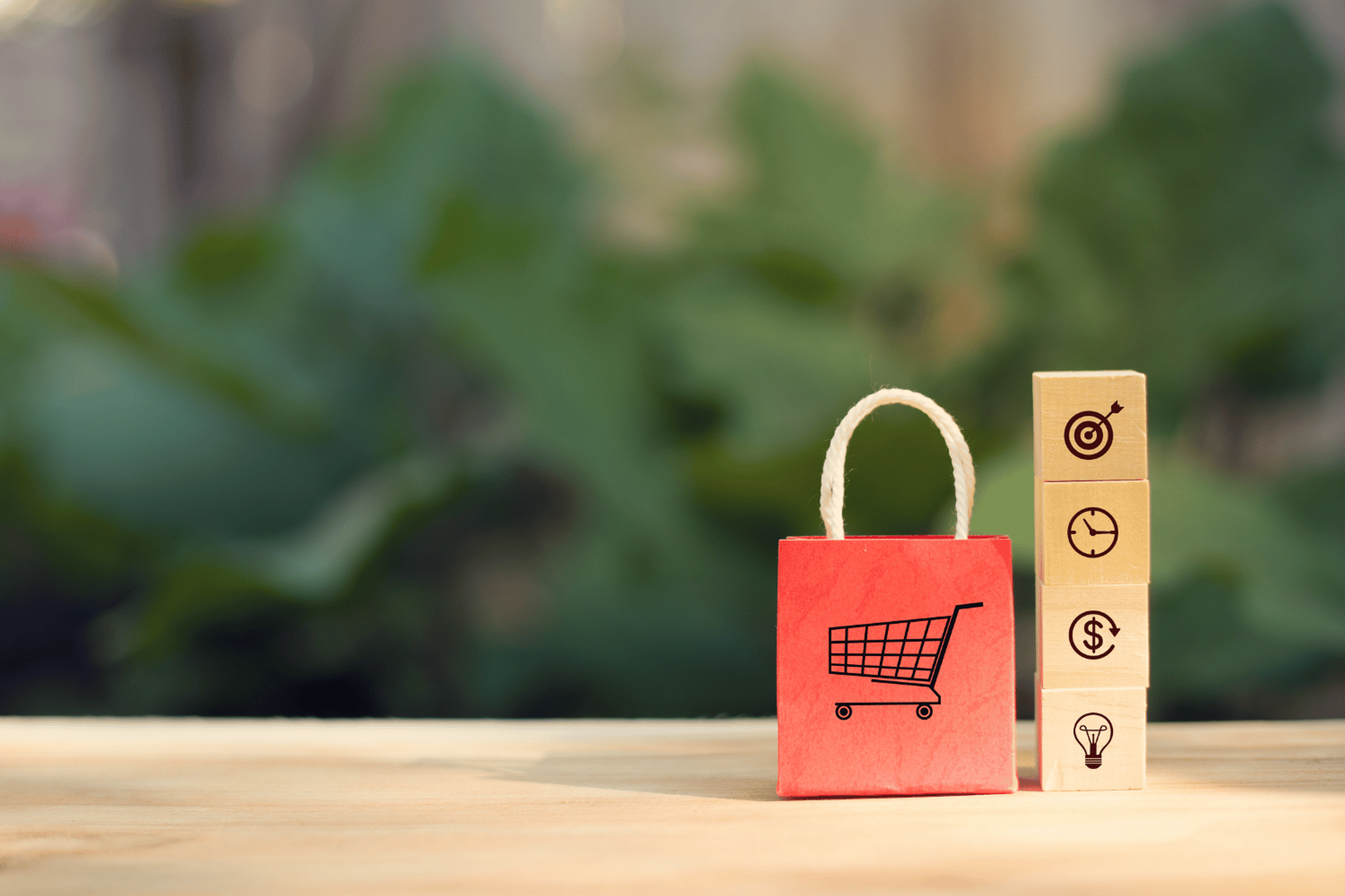 A shopping cart and wooden dices showing sales efficiency icons.
