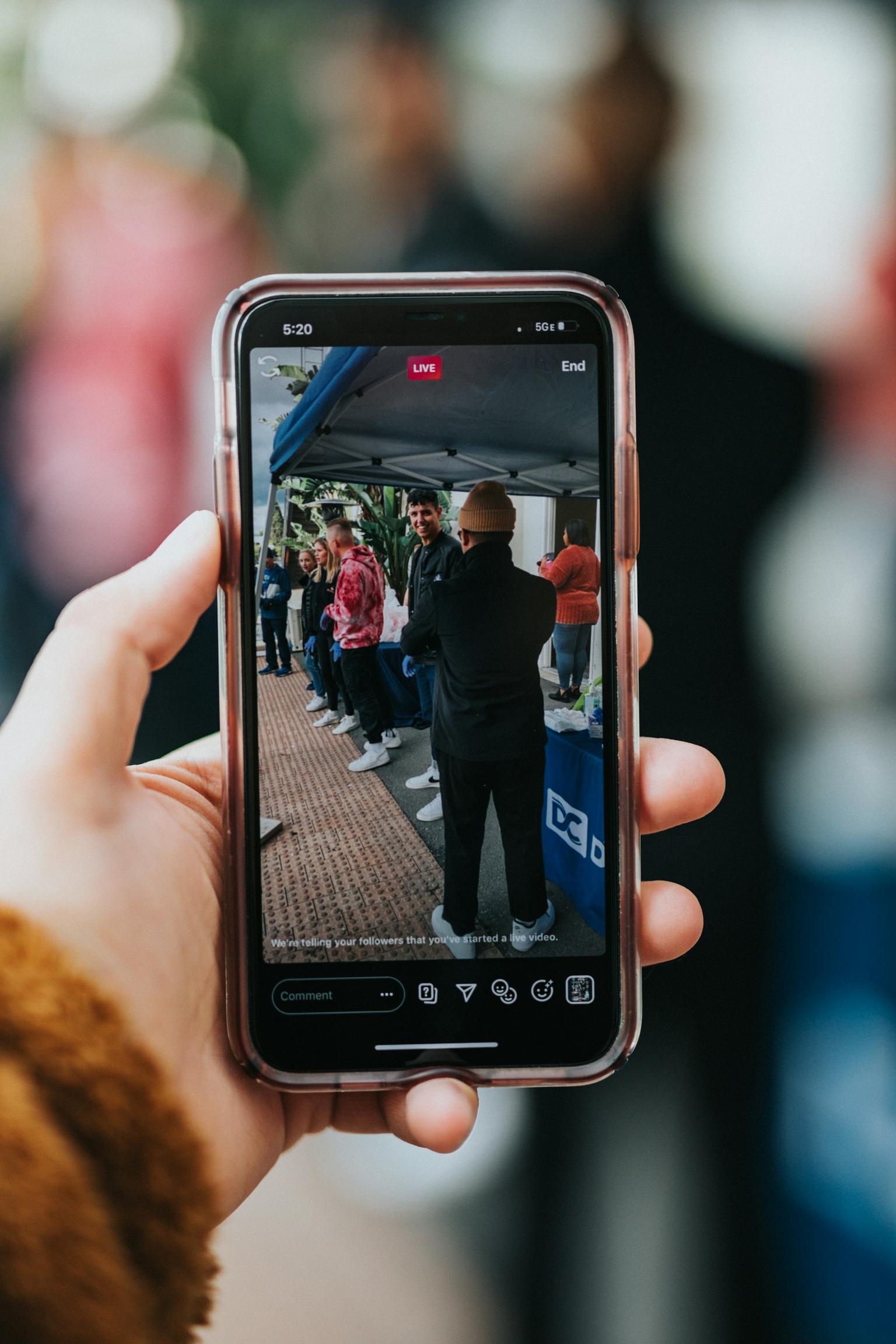 Image of a person holding a phone and recording live on TikTok