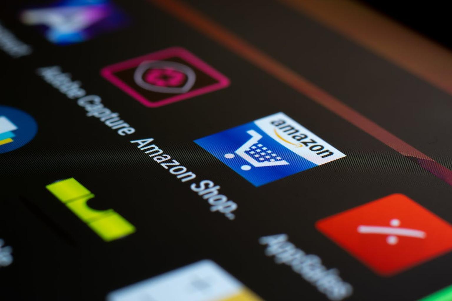 Closeup of a smartphone screen with Amazon Shop application featured among other apps