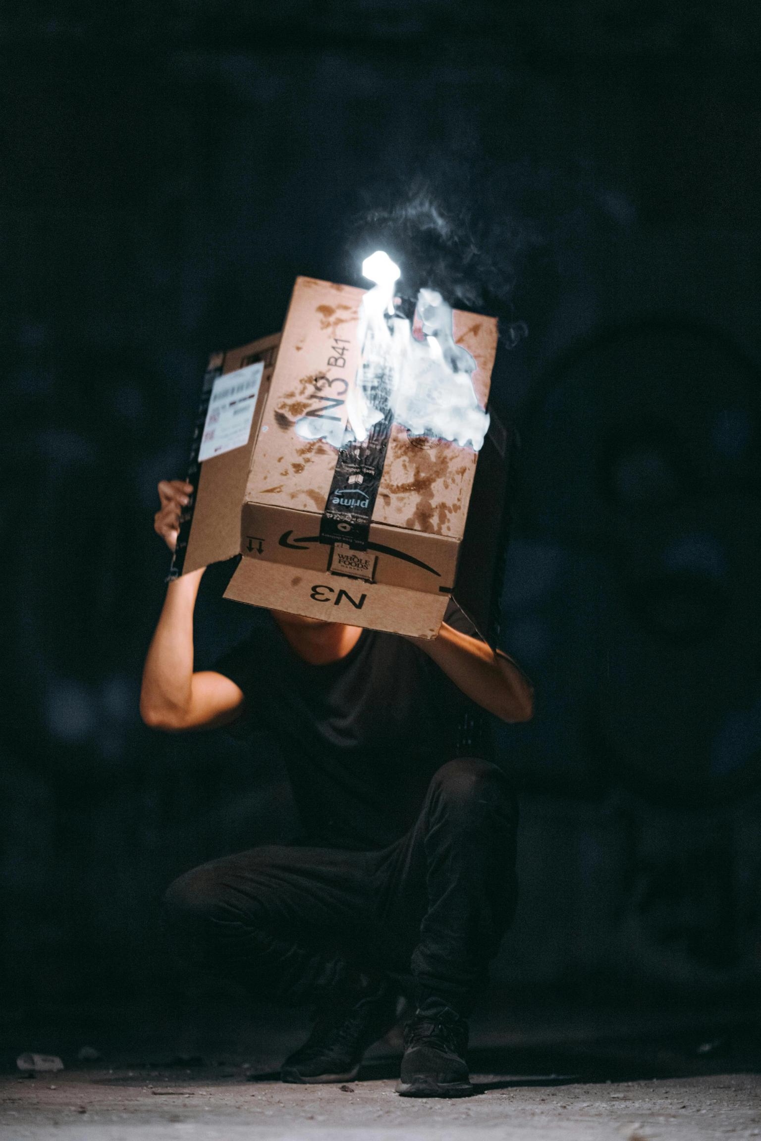 Image of a person burning an Amazon FBA box in front of the camera