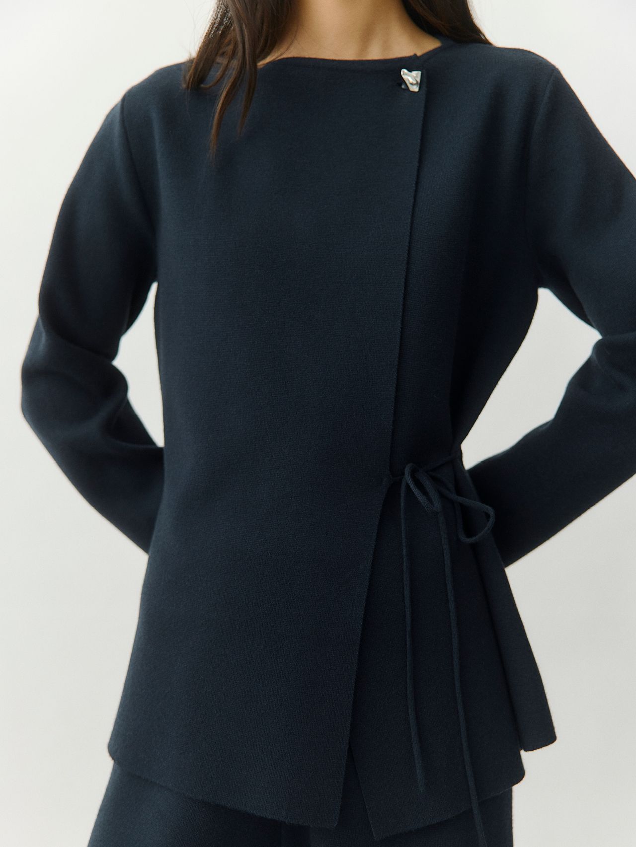 Navy blue asymmetric wrap jacket with side tie, high neck and silver brooch detail