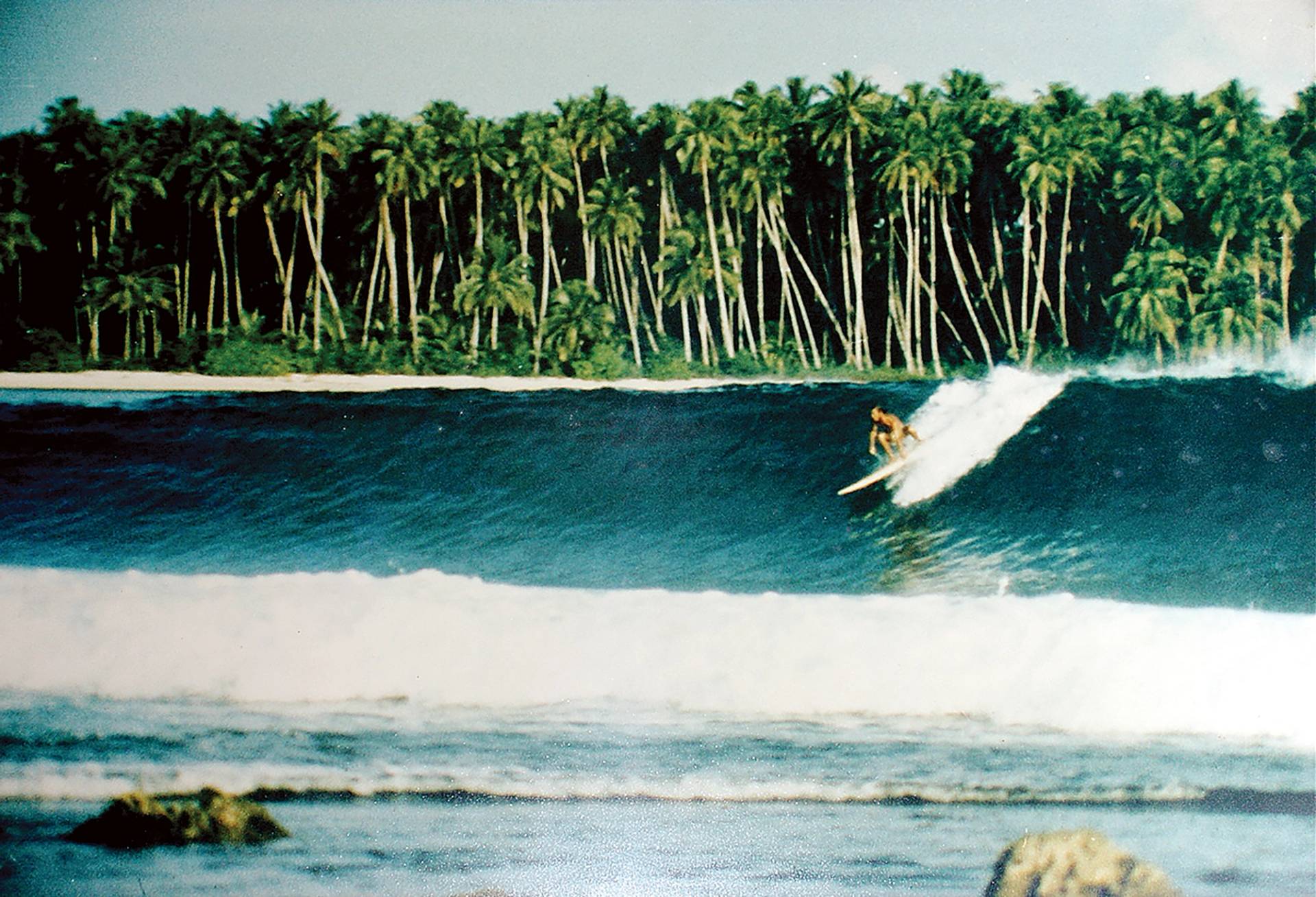 John Geisel realizing the dream, June 30th, 1975. This discovery not only fuelled the dreams of other surfers worldwide, it also changed the future of Nias’ Lagundri Bay community. by Kevin Lovett