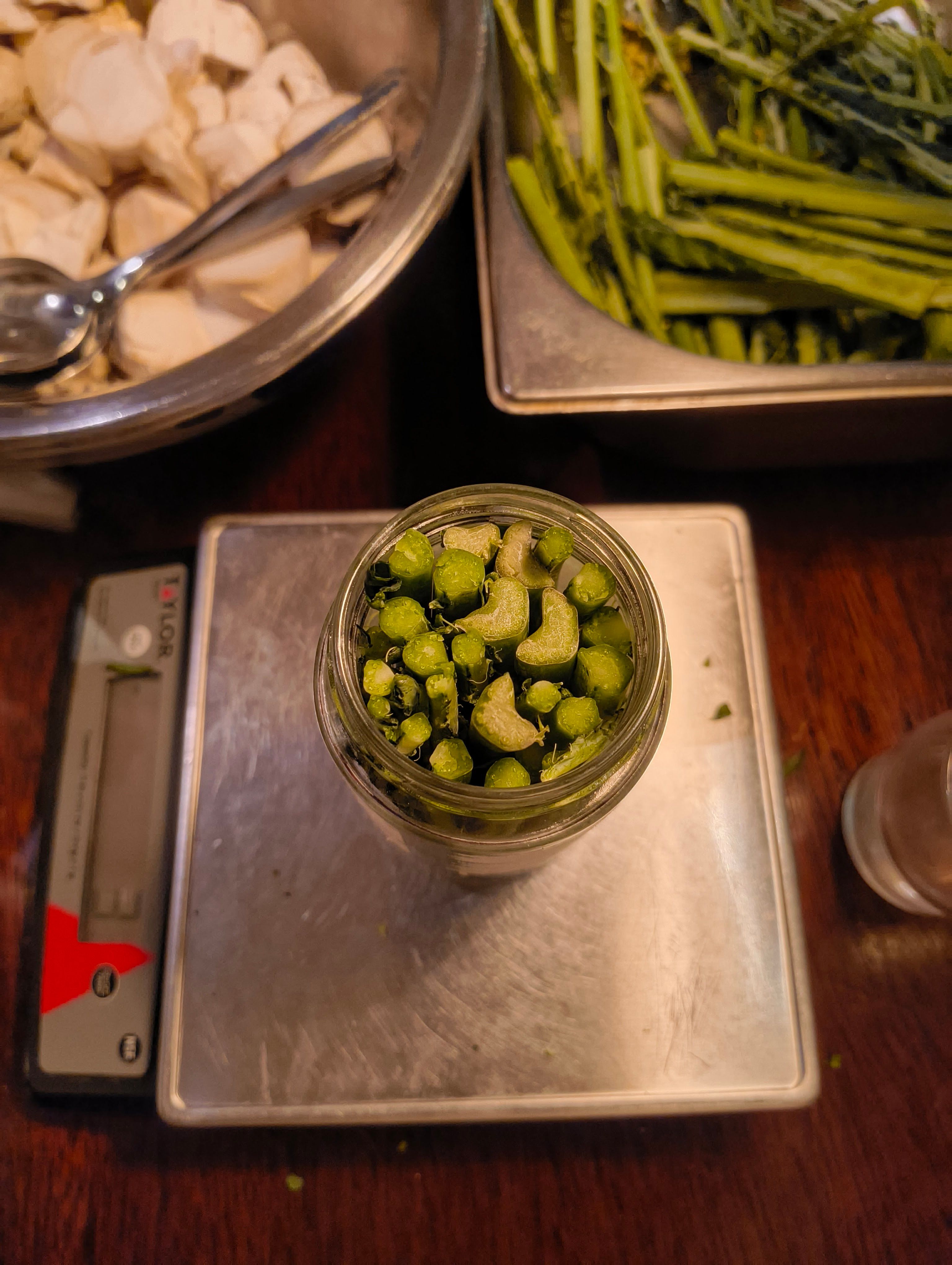 The glass jar was filled with vegetable roots and it was placed on a scale.