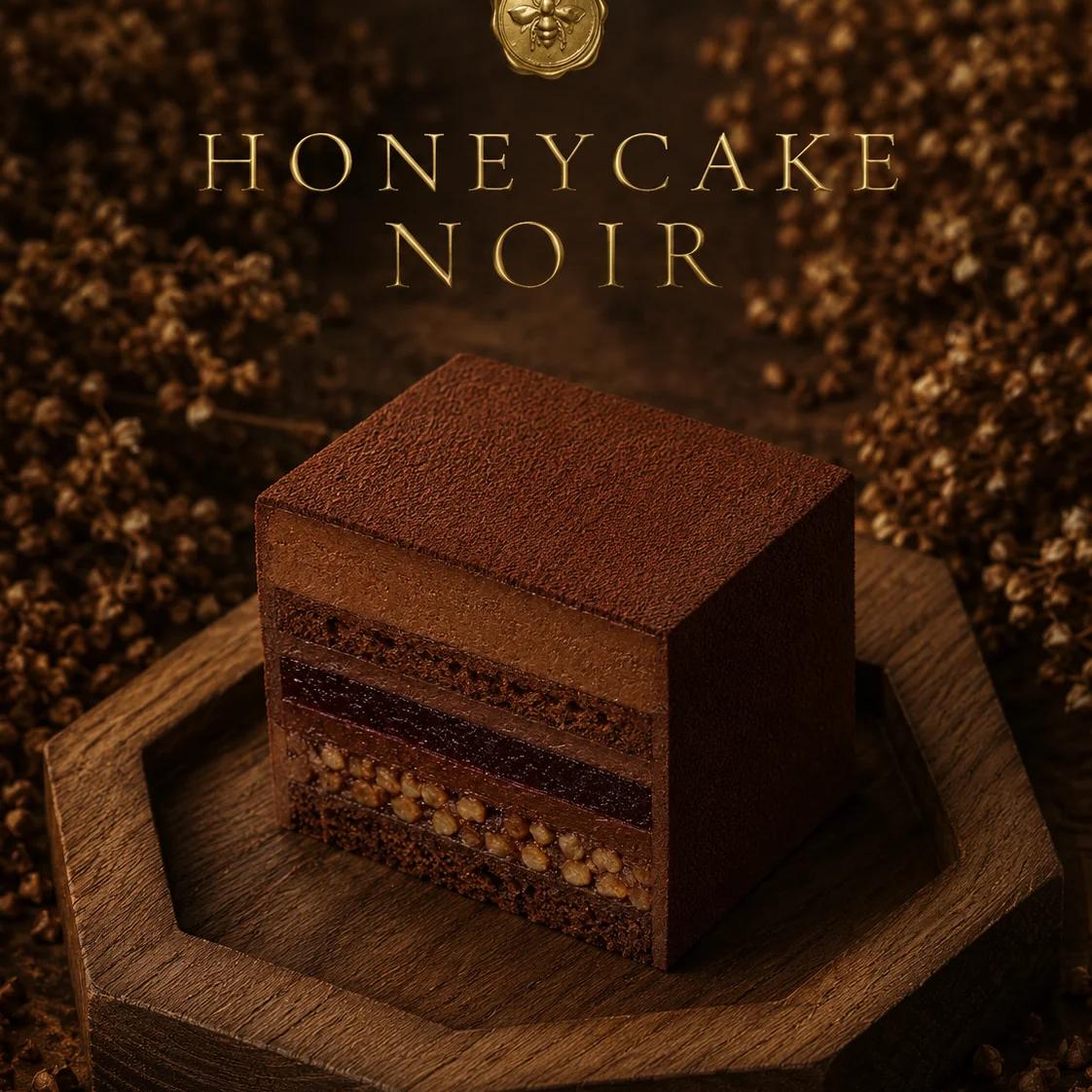 Cross-section of Honeycake Noir — black mousse dome with rye-buckwheat sponge and pecan-bourbon praline.