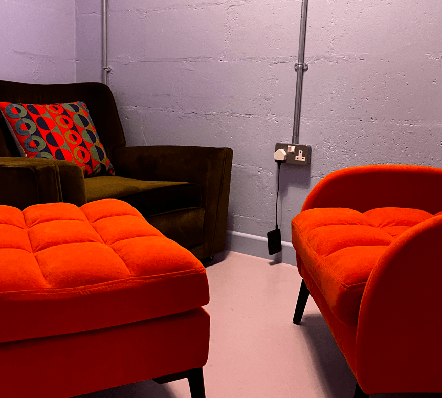 Small room with cushioned seats and footstool