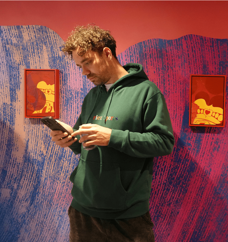 Man on his phone inside a gallery