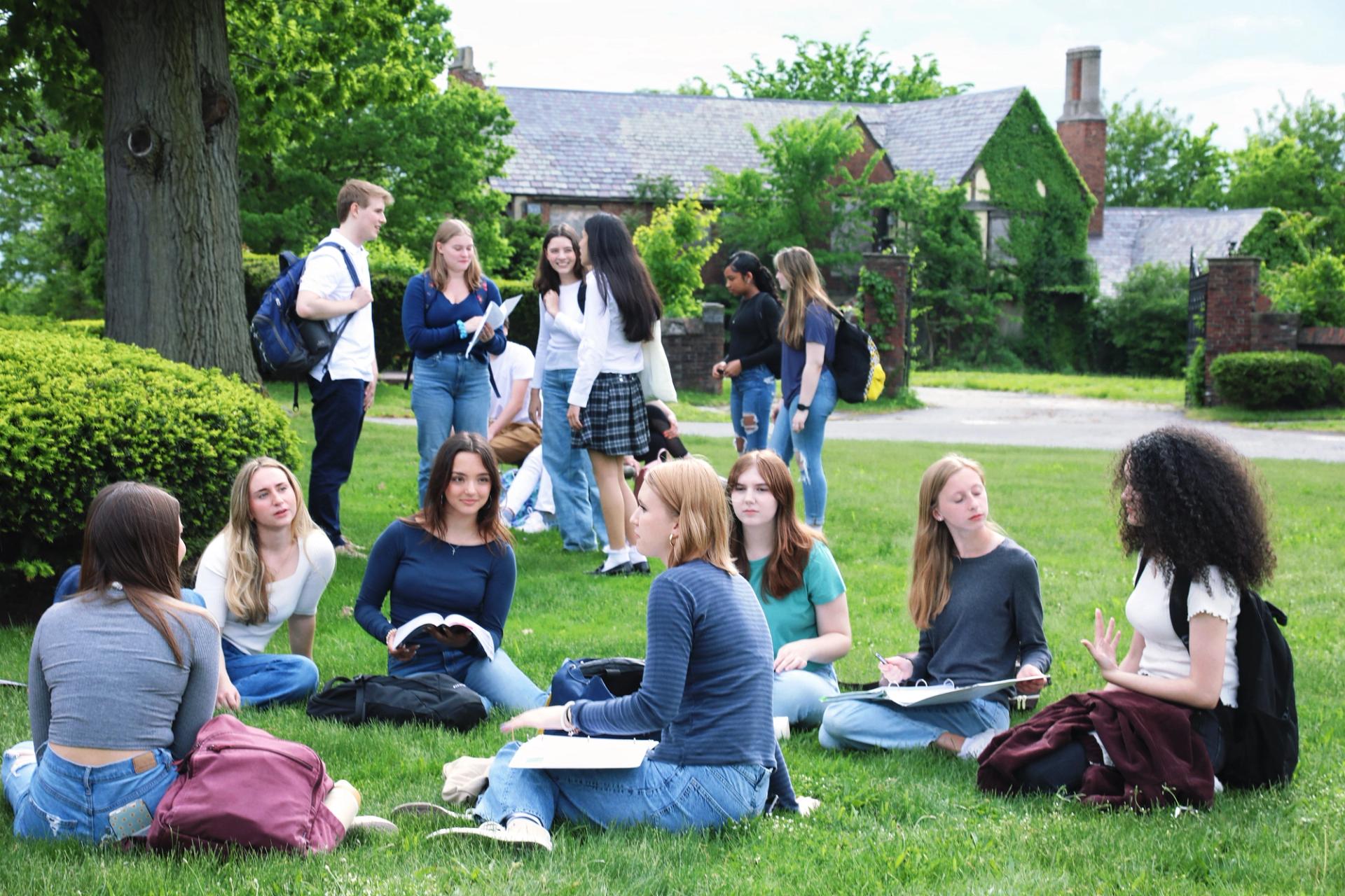 SCA students studying and socializing on the campus lawn