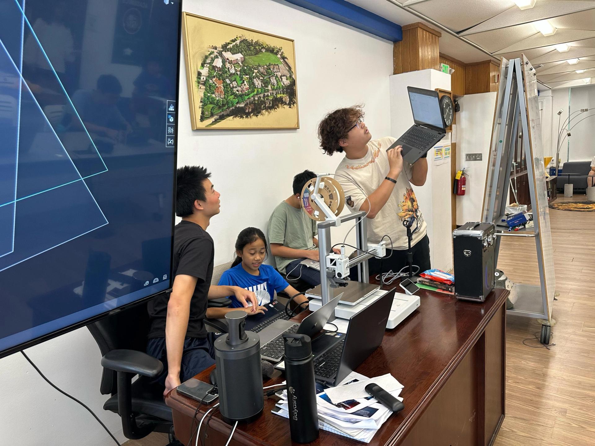 SCA students collaborating on a 3D printing project in the innovation lab