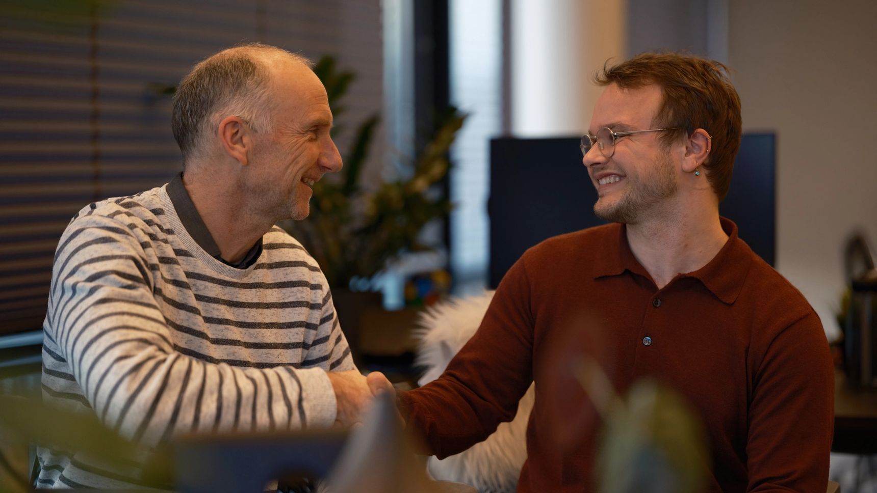 Alex Klijn of Hypersolid and Pim Teeuwisse of Accessibility desk happily shaking hands in Hypersolid's office.