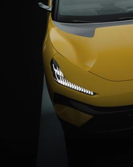 Front view of a yellow Lotus electrical vehicle.