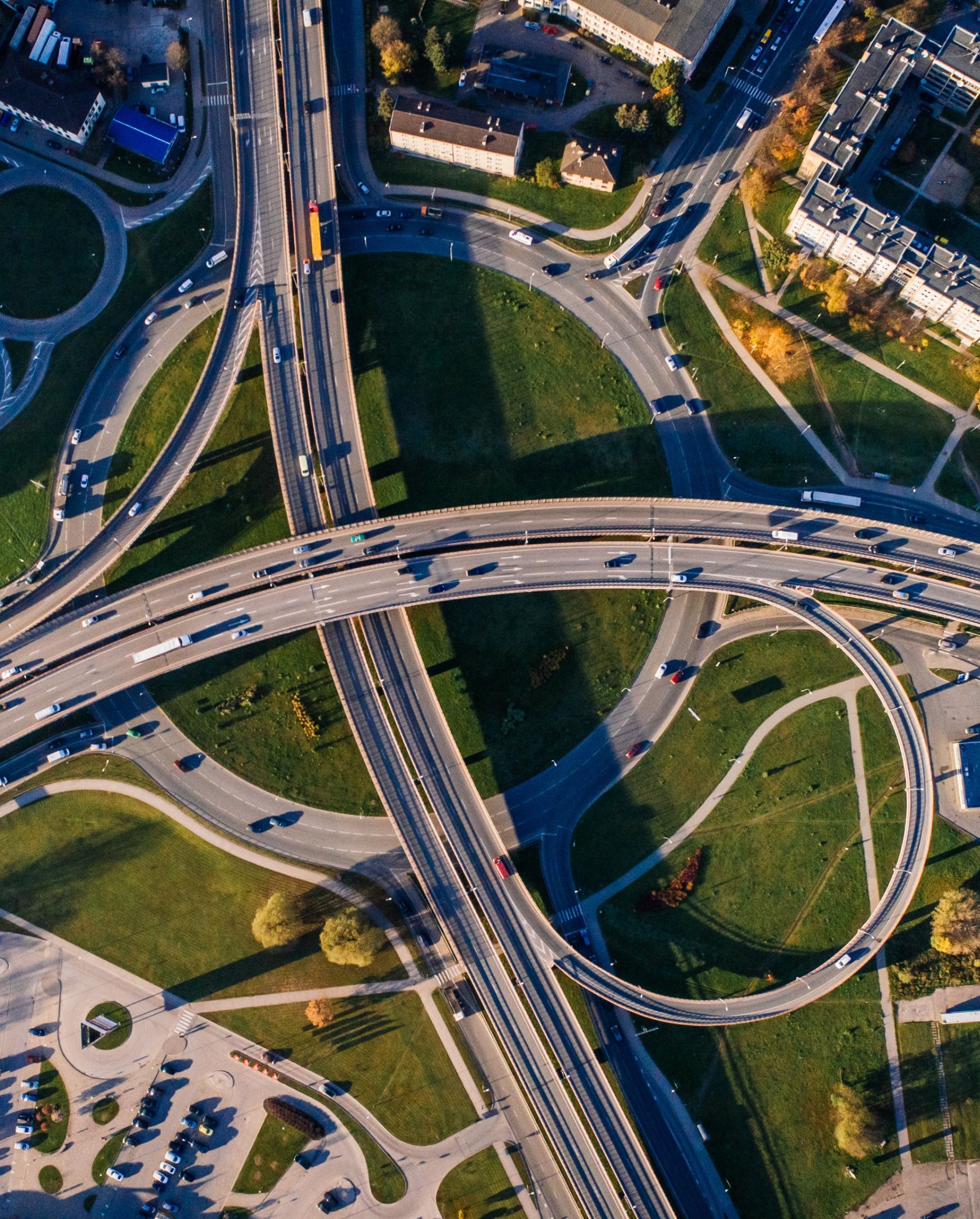 Top view of a traffic junction, different cars driving on it.