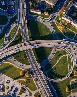 Top view of a traffic junction, different cars driving on it.