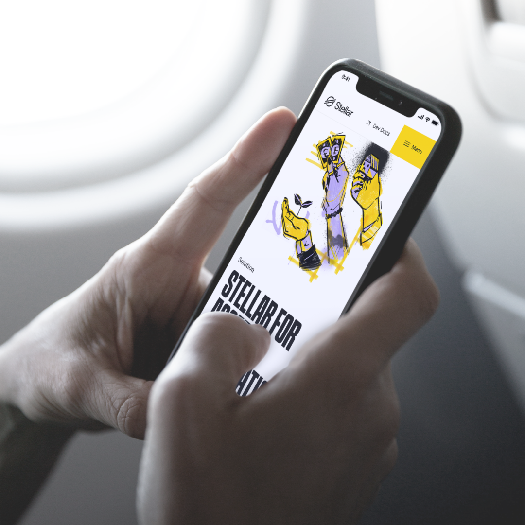 Two hands holding a mobile phone that is displaying the Stellar app.