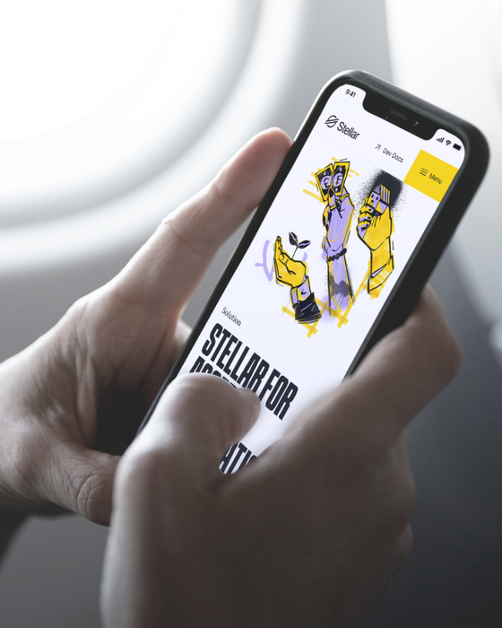 Two hands holding a mobile phone that is displaying the Stellar app.
