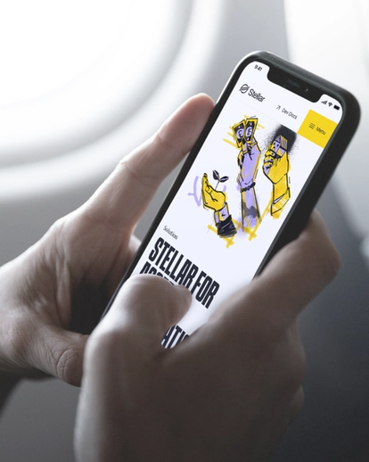Two hands holding a mobile phone that is displaying the Stellar app.
