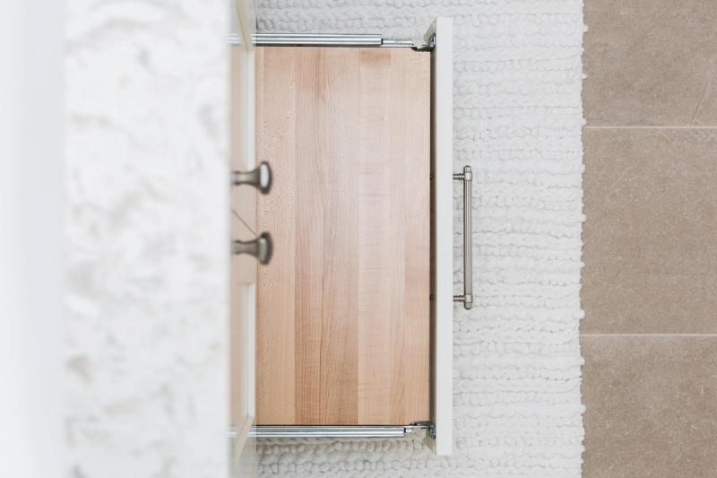White shaker vanity with built-in step stool