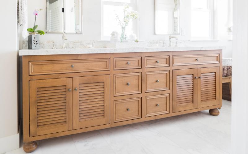 Cherry vanity cabinet with inset face frame and louvered doors