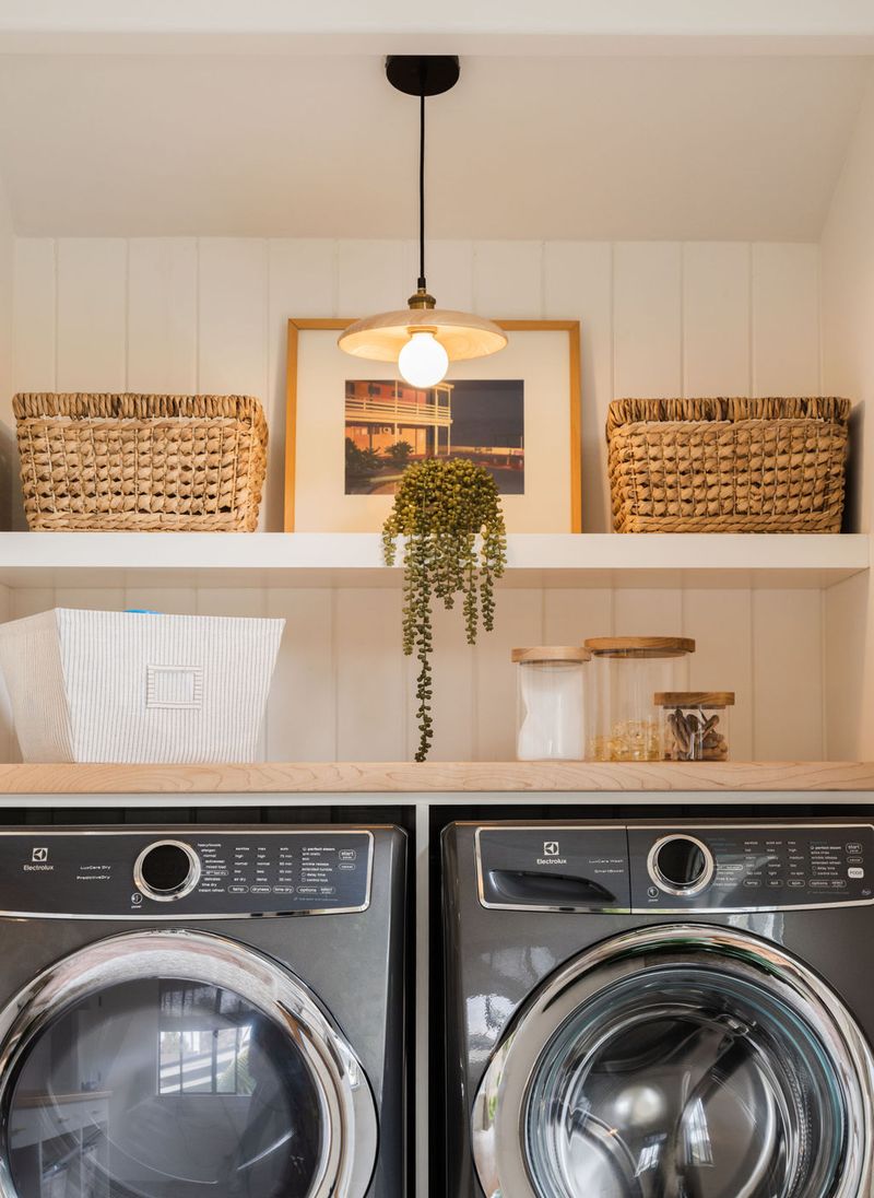 Floating shelf above a washer and dryer