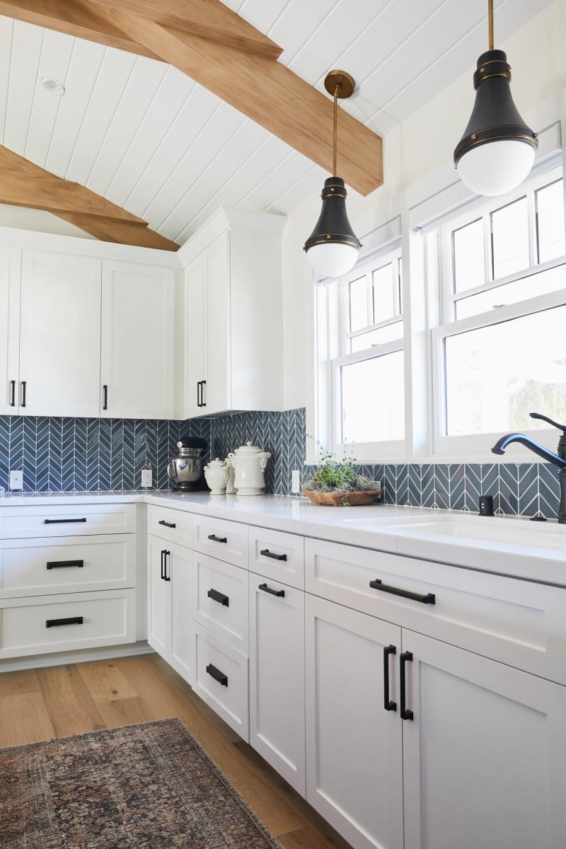 White and navy kitchen with exposed rustic beams