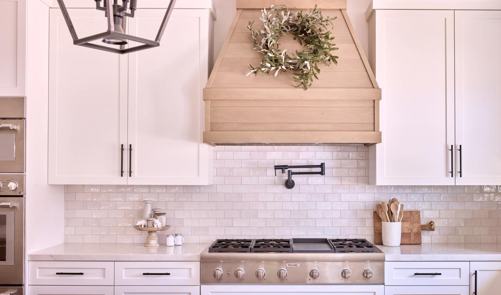 A transitional white oak and painted shaker kitchen with an integrated pet station and farmhouse vibes in Southern California