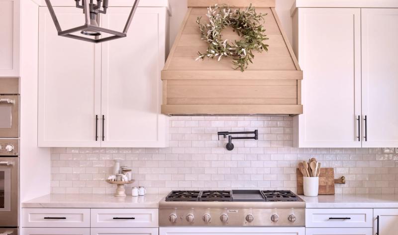 A transitional white oak and painted shaker kitchen with an integrated pet station and farmhouse vibes in Southern California