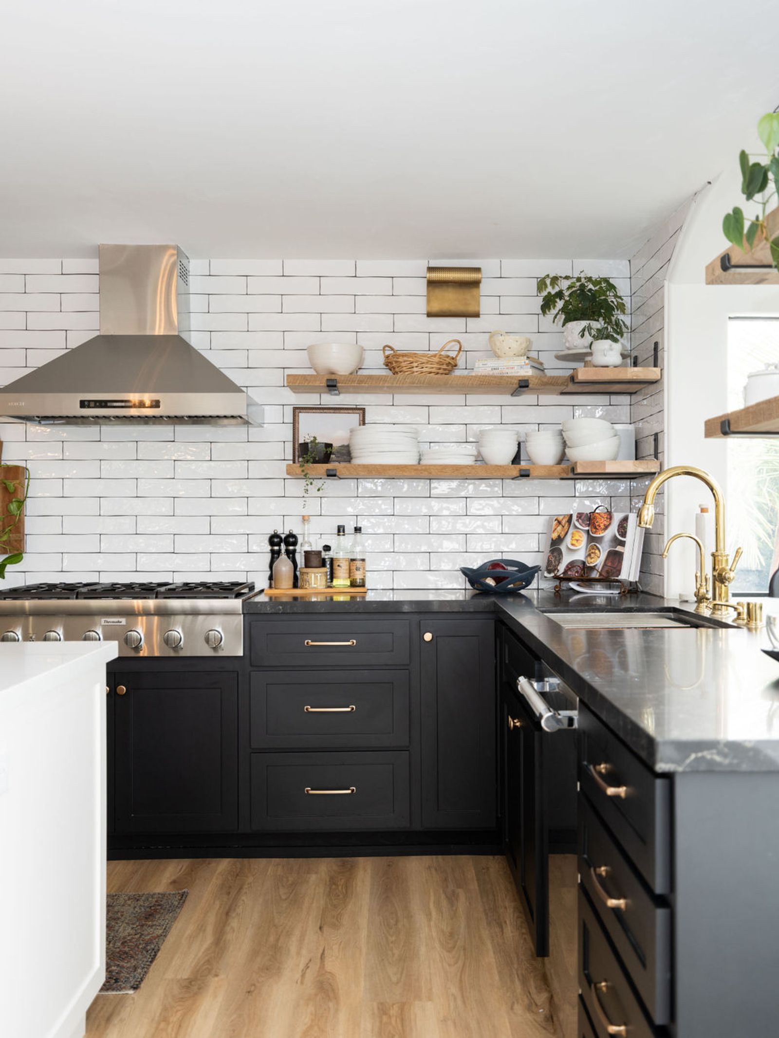 Black and gold matte kitchen corner with floating shelves