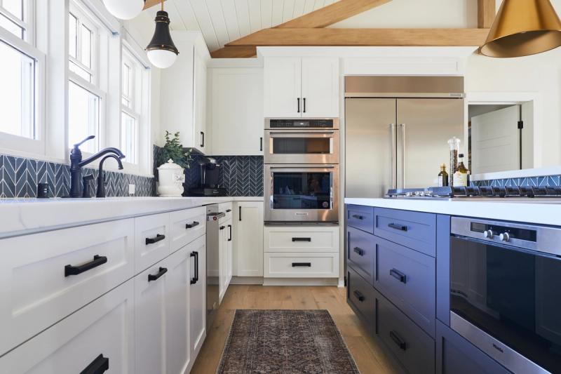 White and navy kitchen with exposed rustic beams