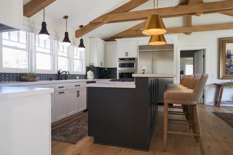 White and navy kitchen with exposed rustic beams