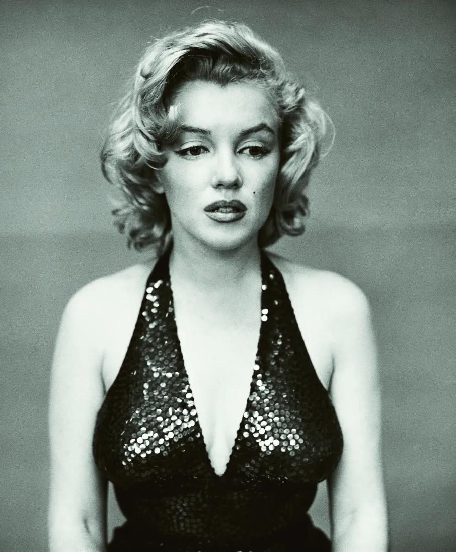Richard Avedon's black and white portrait of Marilyn Monroe in a sequined dress, eyes lowered.