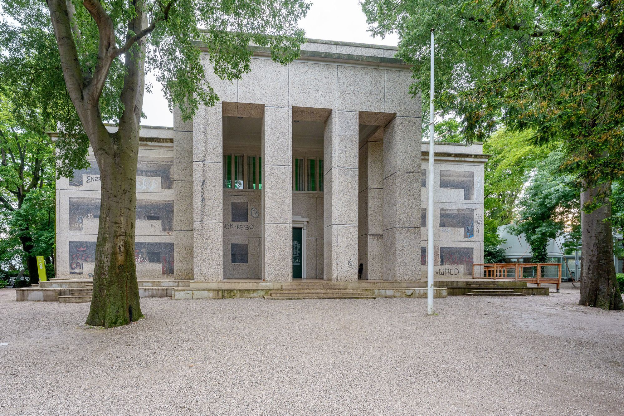 Facade of the German pavilion covered with a printed mosaic of a graffitied East Berlin housing block.