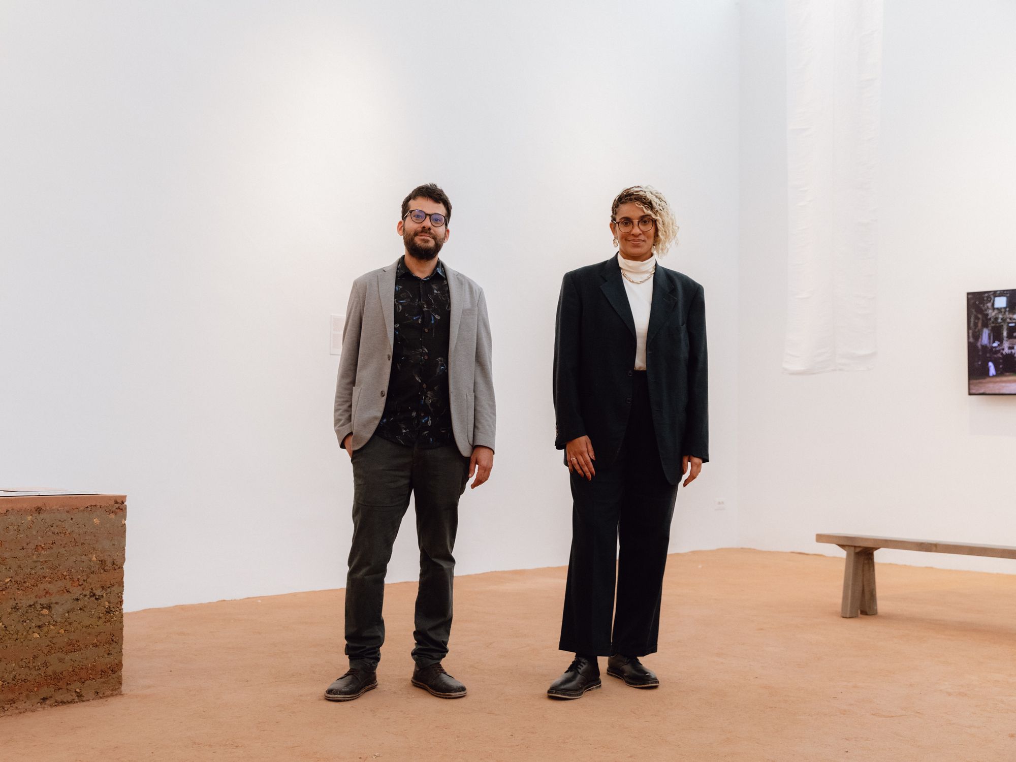 Interior of the Brazilian Pavilion at the 2023 Venice Architecture Biennale with the floor entirely covered in dark earth.