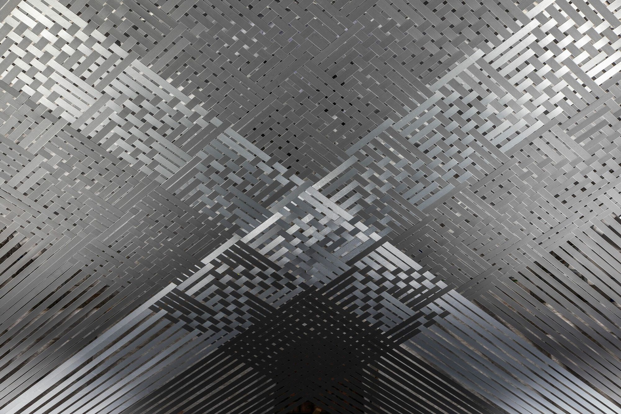 Mataaho Collective's Takapau, a woven canopy of polyester tie-down straps suspended at the entrance of the Arsenale, 60th Venice Biennale 2024.