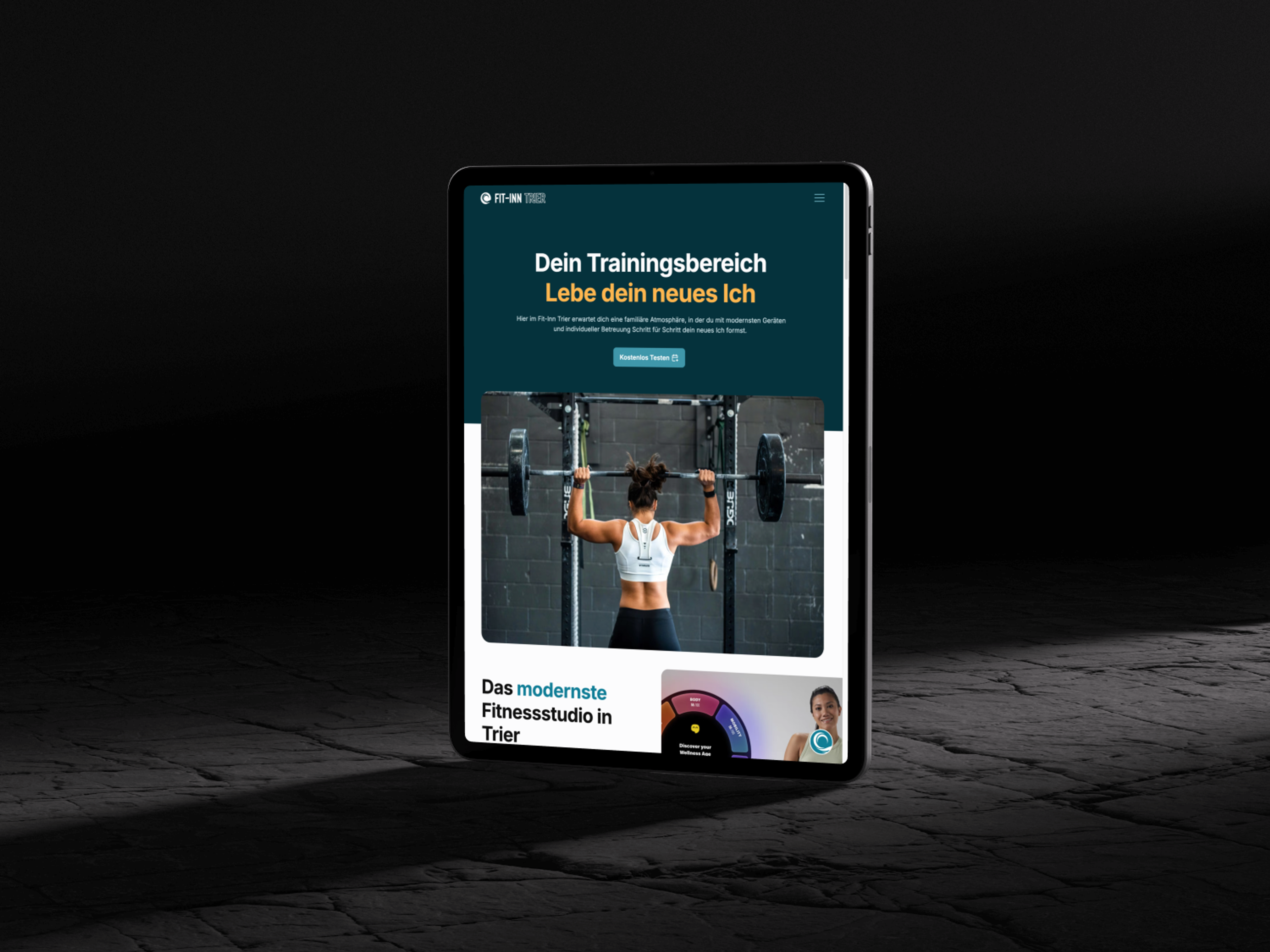 A tablet shows a fitness website with a woman lifting weights