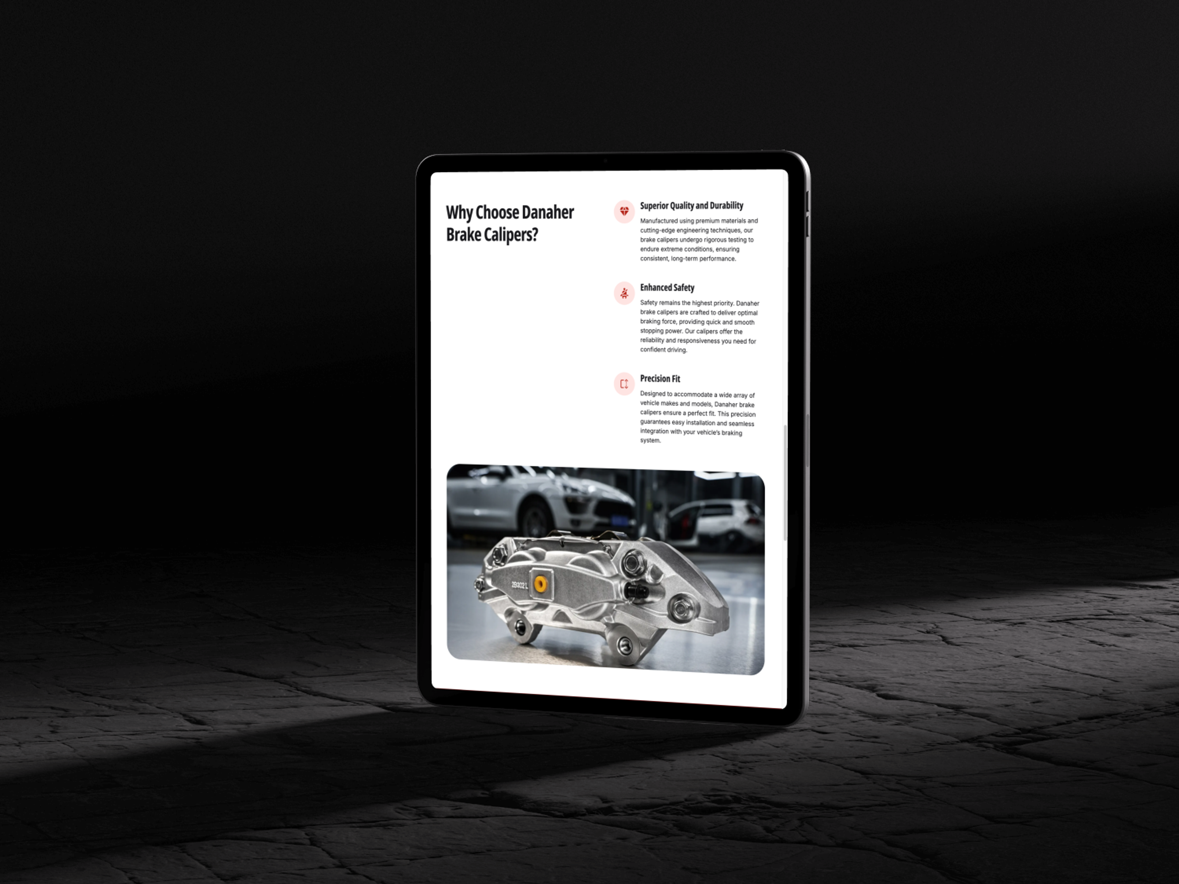 Tablet auf dunklem Boden mit Anzeige von Danaher Bremssätteln und silbernem Auto im Hintergrund.