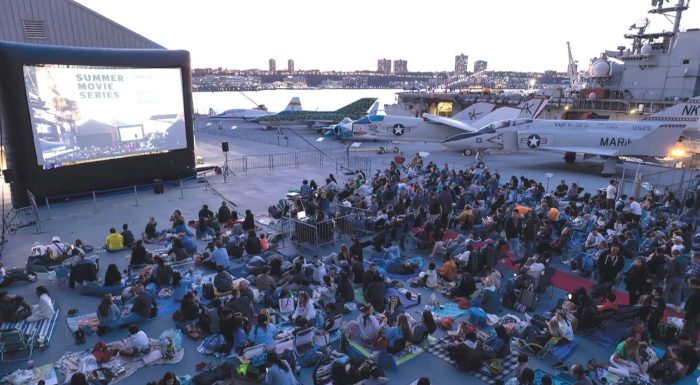 Movie screen and crowds on the Intrepid Museum in New York