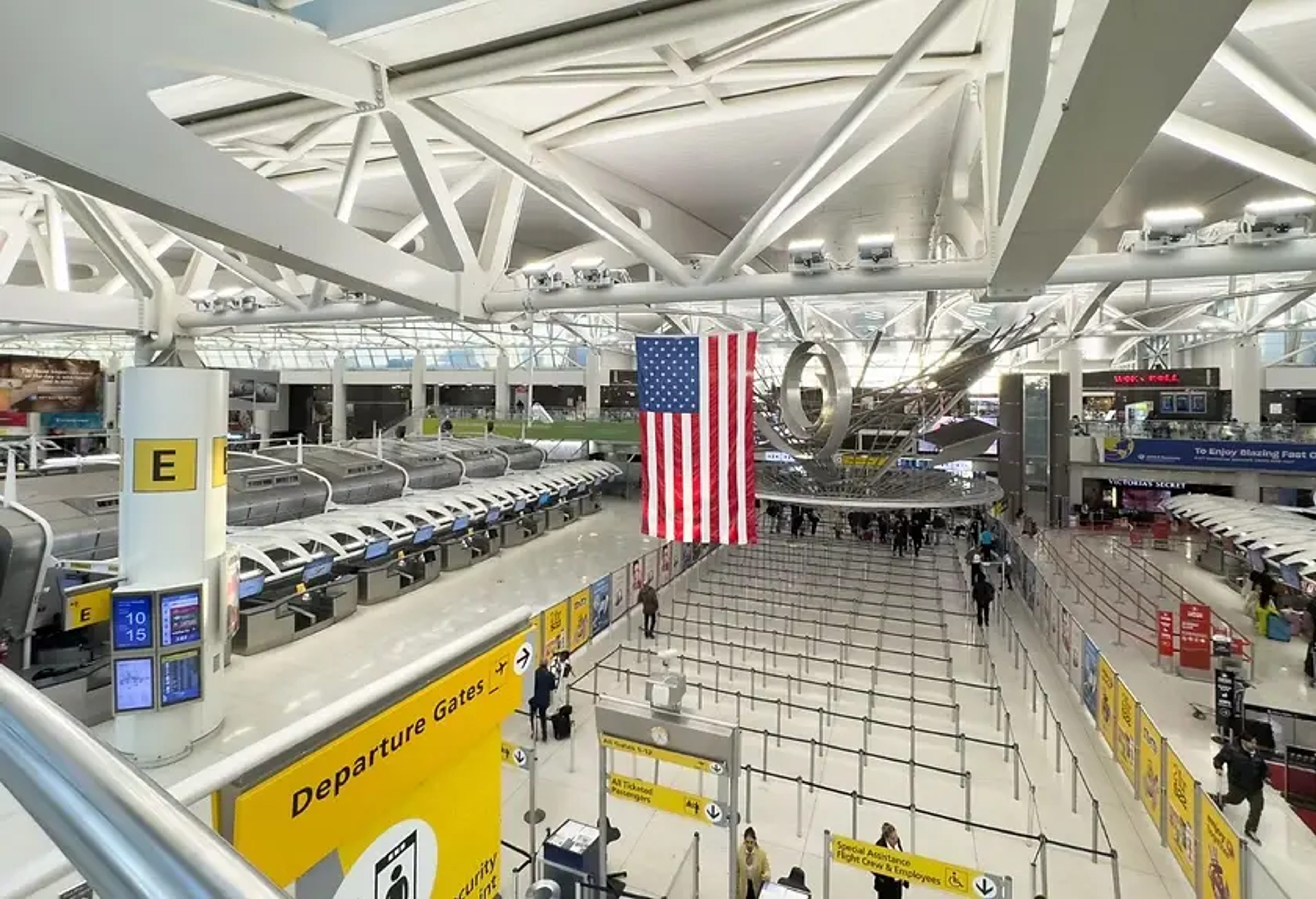 JFK airport terminal with American Flag hanging from the ceiling