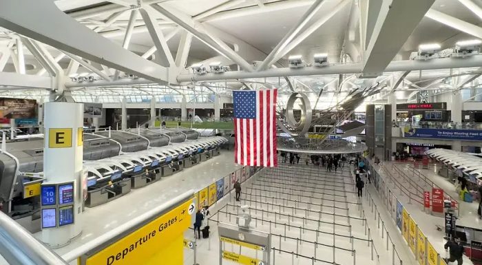 JFK airport terminal with American Flag hanging from the ceiling